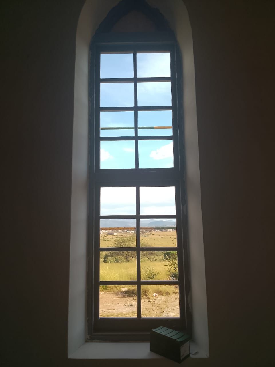 View through a restored arched window onto the open veld