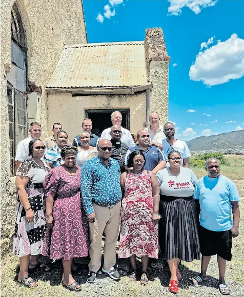 Members of the congregation and contractors gathered at the entrance of the old church at Lesseyton at the start of renovations